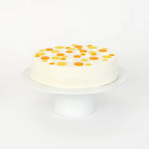 A thumbnail shot of a Lady M Mango Shortcake on top a white cake stand.