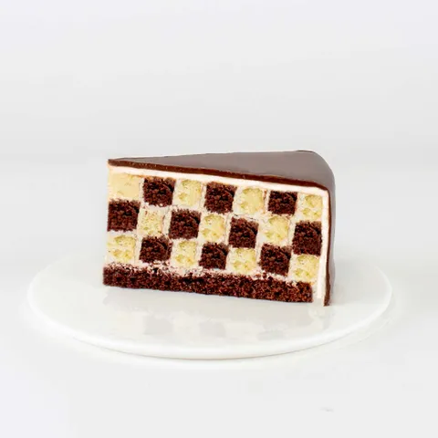 A thumbnail shot of a Lady M Checkers slice on top a white round plate.