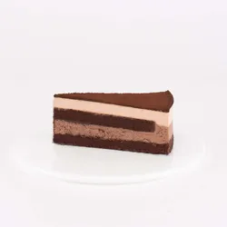 A thumbnail shot of a Lady M Chocolate Arc-en-Ciel slice on top a white round plate.