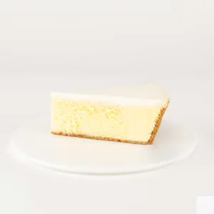 A thumbnail shot of a Lady M Gâteau Nuage slice on top a white round plate.