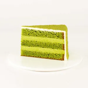 A thumbnail shot of a Lady M Green Tea Mousse slice on top a white round plate.