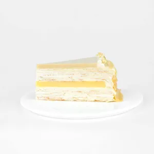 A thumbnail shot of a Lady M Jasmine Calamansi Mille Crêpes slice on top a white round plate.