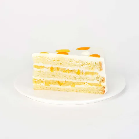 A thumbnail shot of a Lady M Mango Shortcake slice on top a white round plate.