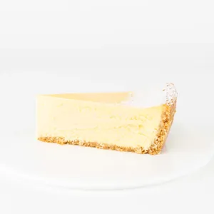 A thumbnail shot of a Lady M Passion Fruit Cheesecake slice on top a white round plate.