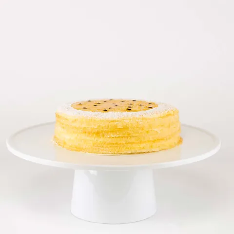 A thumbnail shot of a 6-inch Lady M Passion Fruit Mille Crêpes on top a white cake stand.