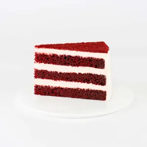 A thumbnail shot of a Lady M Red Velvet slice on top a white round plate.