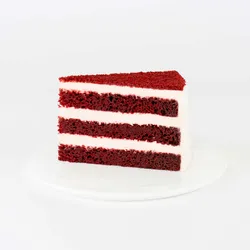 A thumbnail shot of a Lady M Red Velvet slice on top a white round plate.