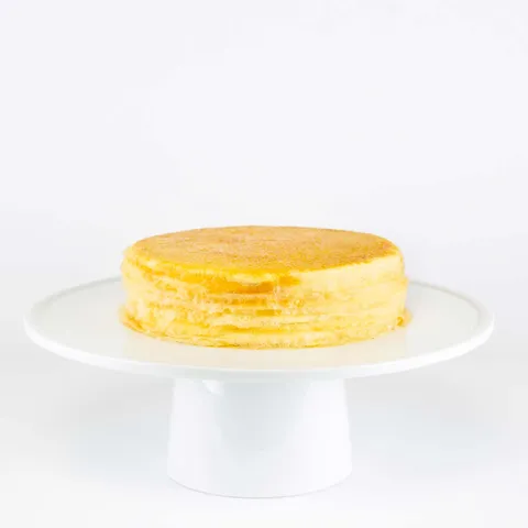 A thumbnail shot of a 6-inch Lady M Signature Mille Crêpes on top a white cake stand.