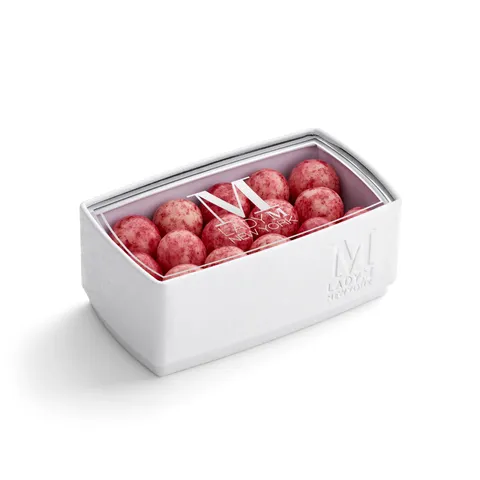 A thumbnail shot of a Lady M Lucky Lychee Pearls encased inside a packaging with a Lady M logo.