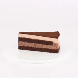 A slice of Lady M's Chocolate Arc-en-Ciel, on top a white round plate.