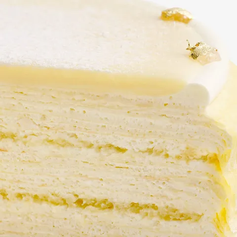 Close-up shot of Lady M's Dassai Blue Mille Crêpes. Layers of crêpes, sponge cake and pastry cream.