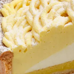 Close-up shot of Lady M's Sweet Corn Tart. Shortbread crust, layers of sweet corn mousse, and cream.