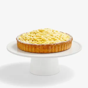 A thumbnail shot of a whole Lady M Sweet Corn Tart, on top a white cake stand.