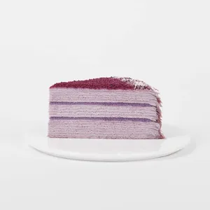 A thumbnail shot of Lady M's Purple Yam Mille Crêpes slice on top a white round plate.