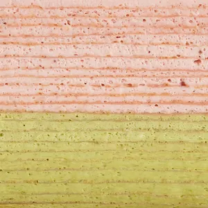 Detail shot of Lady M's Strawberry Matcha Mille Crêpes. Layers of strawberry and matcha crêpes.