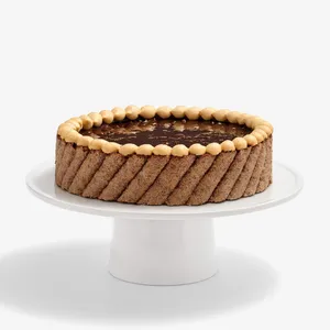 A thumbnail shot of a whole Lady M's Noisettes Chocolat cake, on top of a white cake stand.