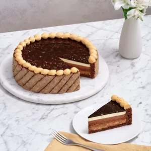 A thumbnail shot of a Lady M Noisettes Chocolat cake with one slice served on a marble table top.