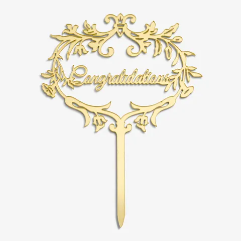 Close-up shot of Lady M's gold Cake Topper spelling out the words: "Congratulations".