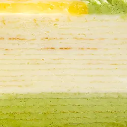 A detail shot of Lady M's Yuzu Matcha Mille Crêpes. Showing distinct crêpe and cream layers.