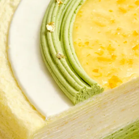 Close-up shot of Lady M's Yuzu Matcha Mille Crêpes, showing distinct crêpe and cream layers.