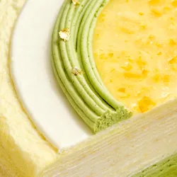 Close-up shot of Lady M's Yuzu Matcha Mille Crêpes, showing distinct crêpe and cream layers.