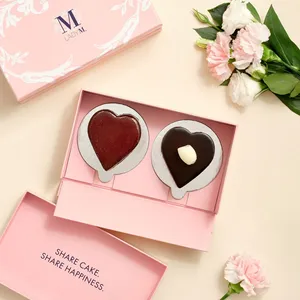 Set of Lady M Couronne du Chocolat and Framboise au Chocolat Valentine Heart cake on pink backdrop.