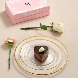 Lady M's Couronne du Chocolat mini heart cake on a clear glass plate set on a beige linen.