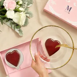 A top-down of Lady M's Framboise au Chocolat Valentine Heart mini cake on a plate and mini box case