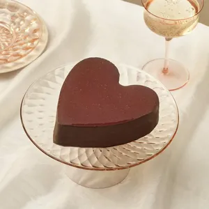 Framboise au Chocolat Valentine Heart cake on a clear glass cake stand over a pink linen.
