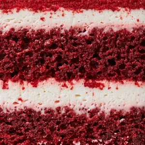 Close-up of rich layered red velvet cake.