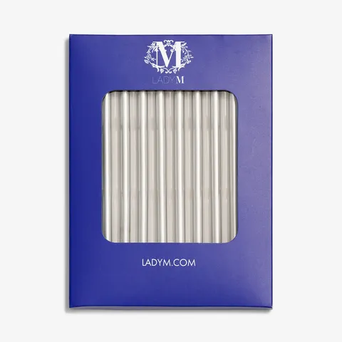 Silver Lady M candles in blue box on white background.