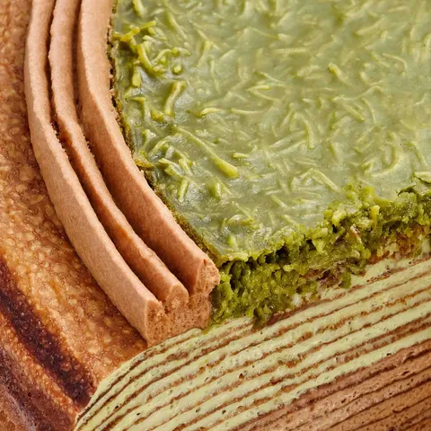 Close-up of Lady M's Dubai Chocolate Mille Crêpes with chocolate, pistachio & green knafeh.