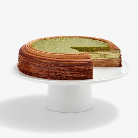 Sliced Lady M Dubai Chocolate Mille Crêpes with chocolate, pistachio cream & green knafeh.