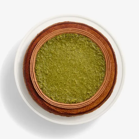 Top-down view of Lady M's Dubai Chocolate Mille Crêpes with chocolate cream & green knafeh.