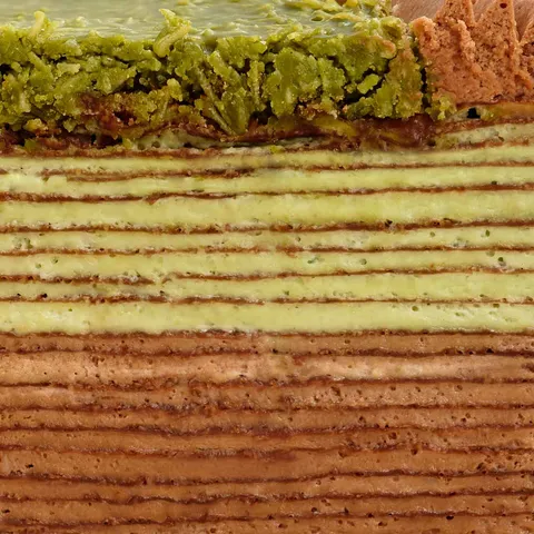 Close-up of Lady M's Dubai Chocolate Mille Crêpes with chocolate, pistachio & knafeh layers.