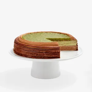 Sliced Dubai Chocolate cake: layers of crepes, chocolate/pistachio cream, topped with crispy kataifi.