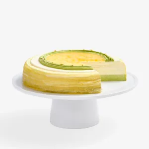 Sliced Yuzu Matcha Mille Crêpes: crepes, matcha/yuzu cream, yuzu glaze/peel, gold leaf.