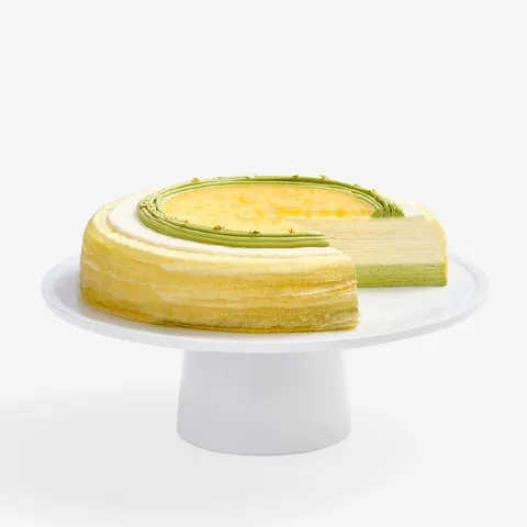 Sliced Yuzu Matcha Mille Crêpes: crepes, matcha/yuzu cream, yuzu glaze/peel, gold leaf.