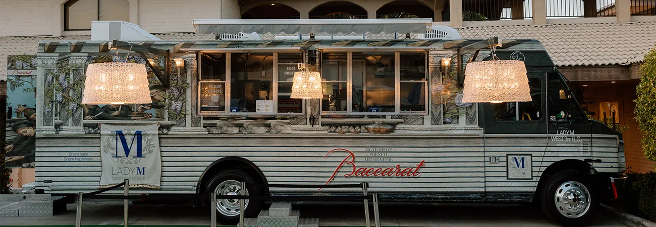 Lady M x Baccarat Luxury Cake Truck Exterior with hanging crystal chandeliers shining bright