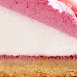 Close up image of a Berry Mont Blanc Tart slice showcasing the tart crust, fresh whipped cream, and the four-berry mousse on top.