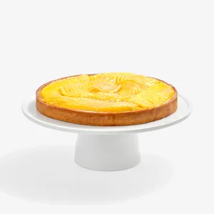 Lady M’s Tarte à la Mangue with golden crust, passion fruit cream, and glazed mango slices.
