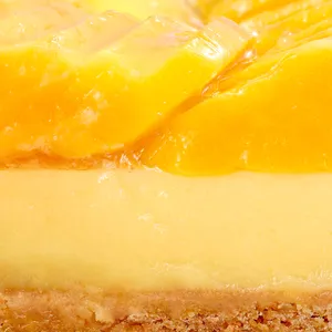 Close-up of Lady M's Tarte à la Mangue showing passion fruit cream and glazed mango topping.