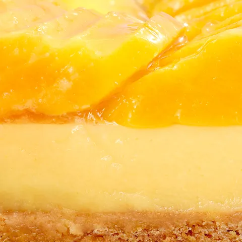 Close-up of Lady M's Tarte à la Mangue showing passion fruit cream and glazed mango topping.