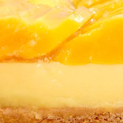 Close-up of Lady M's Tarte à la Mangue showing passion fruit cream and glazed mango topping.