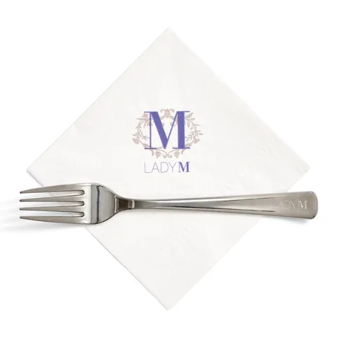 Lady M white napkin with blue logo and custom engraved silver fork for takeout.