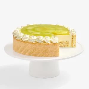 Lady M's Charlotte au Melon cake with a slice removed, on a white cake stand.