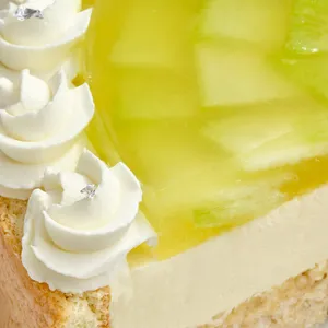 Close-up of Lady M's Charlotte au Melon cake with melon jelly, cream, and silver leaf accents.