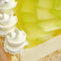 Close-up of Lady M's Charlotte au Melon cake with melon jelly, cream, and silver leaf accents.