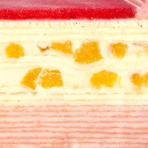 A close-up of the layers of Peach Melba Mille Crêpes, showing peaches, vanilla and raspberry cream.