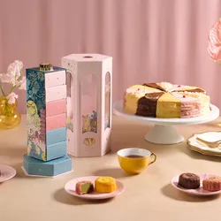 Lady M Mid-Autumn Gift Set with mooncakes and a colorful Slice of the Best cake on a pink table setting.